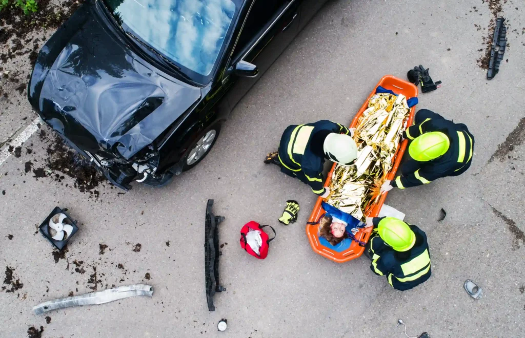 an injured woman in a plastic stretcher after a car accident